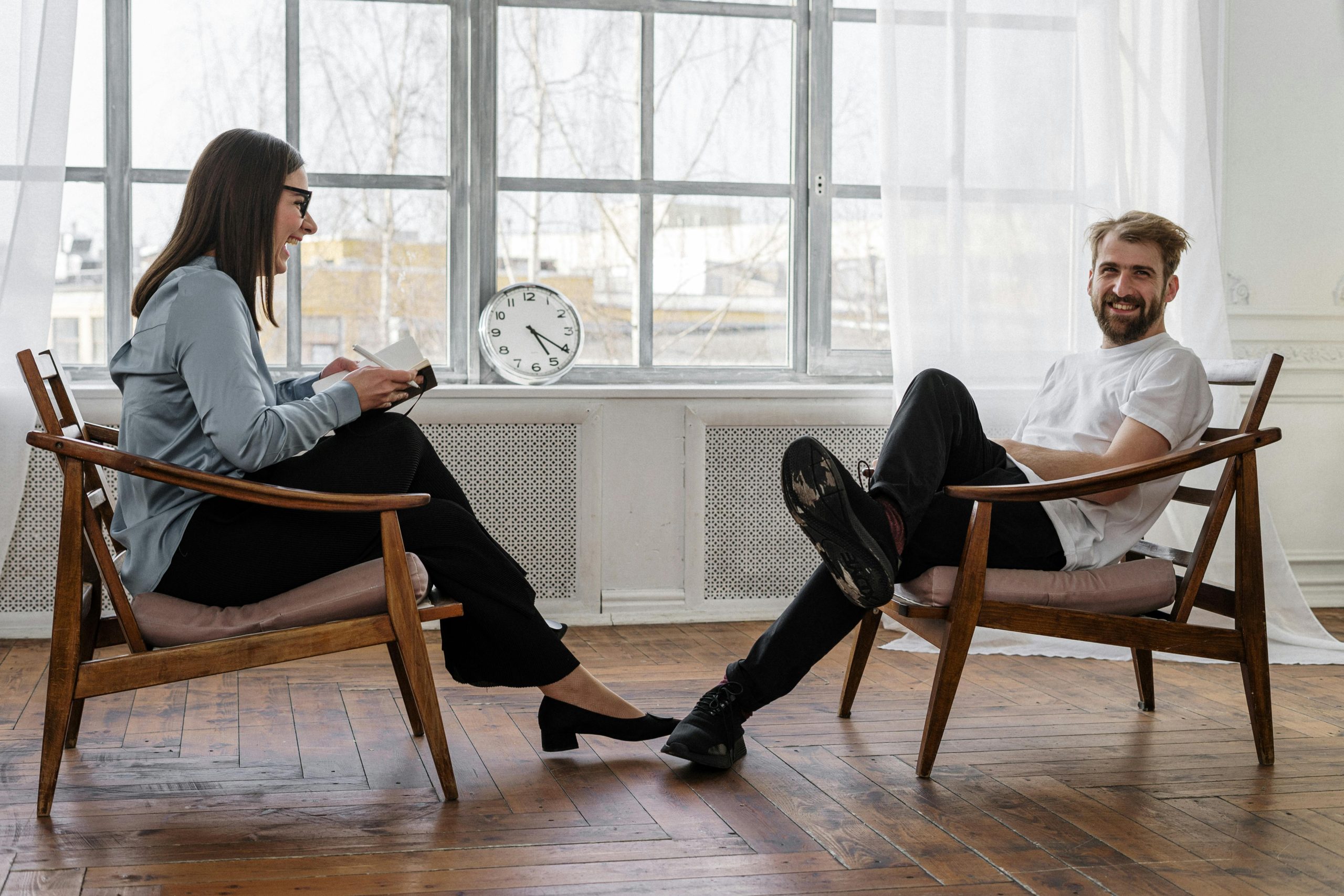 A therapist having a conversation with a man who is smiling