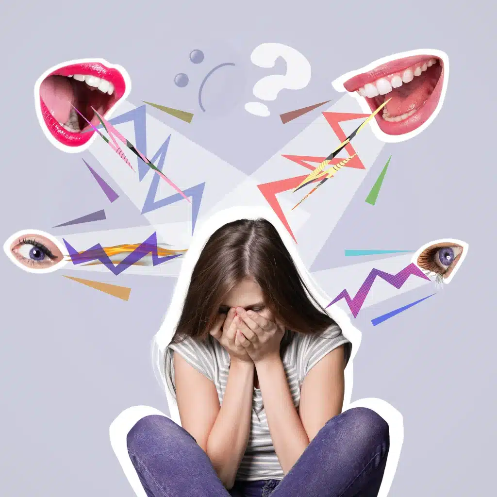 Girl sits cross‑legged with face in hands, surrounded by chaotic abstract shapes and facial features, conveying anxiety or overwhelm.